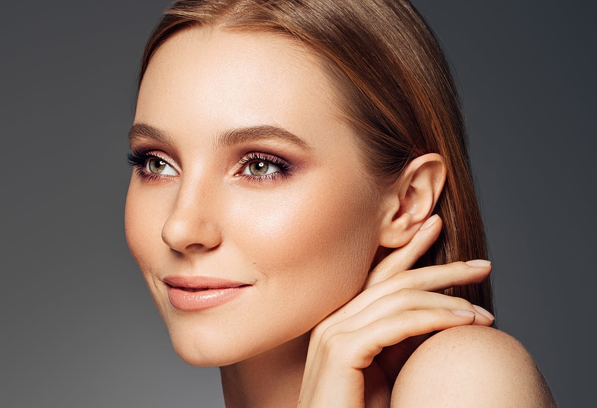 Close-up of a woman's face with soft makeup.