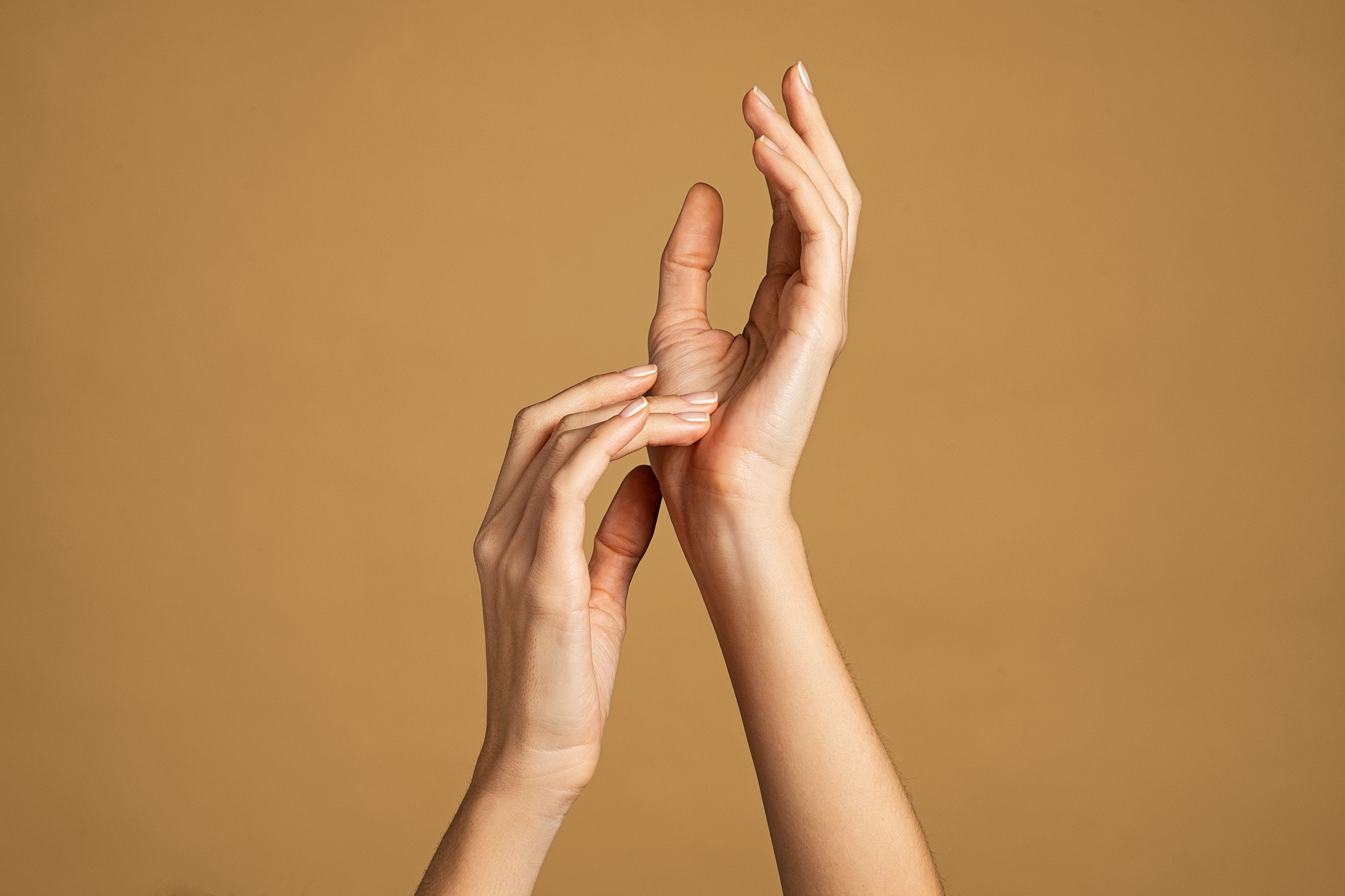 Hands interacting against a warm background.